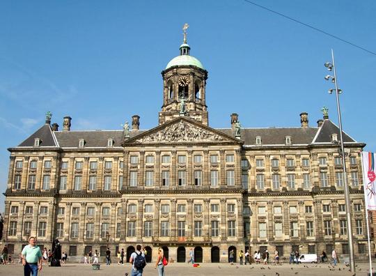 Admire classical architecture of Royal Palace of Amsterdam